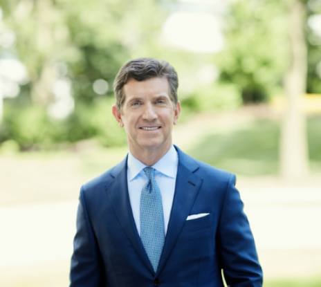 Portrait of Alex Gorsky in a suit and tie standing outside