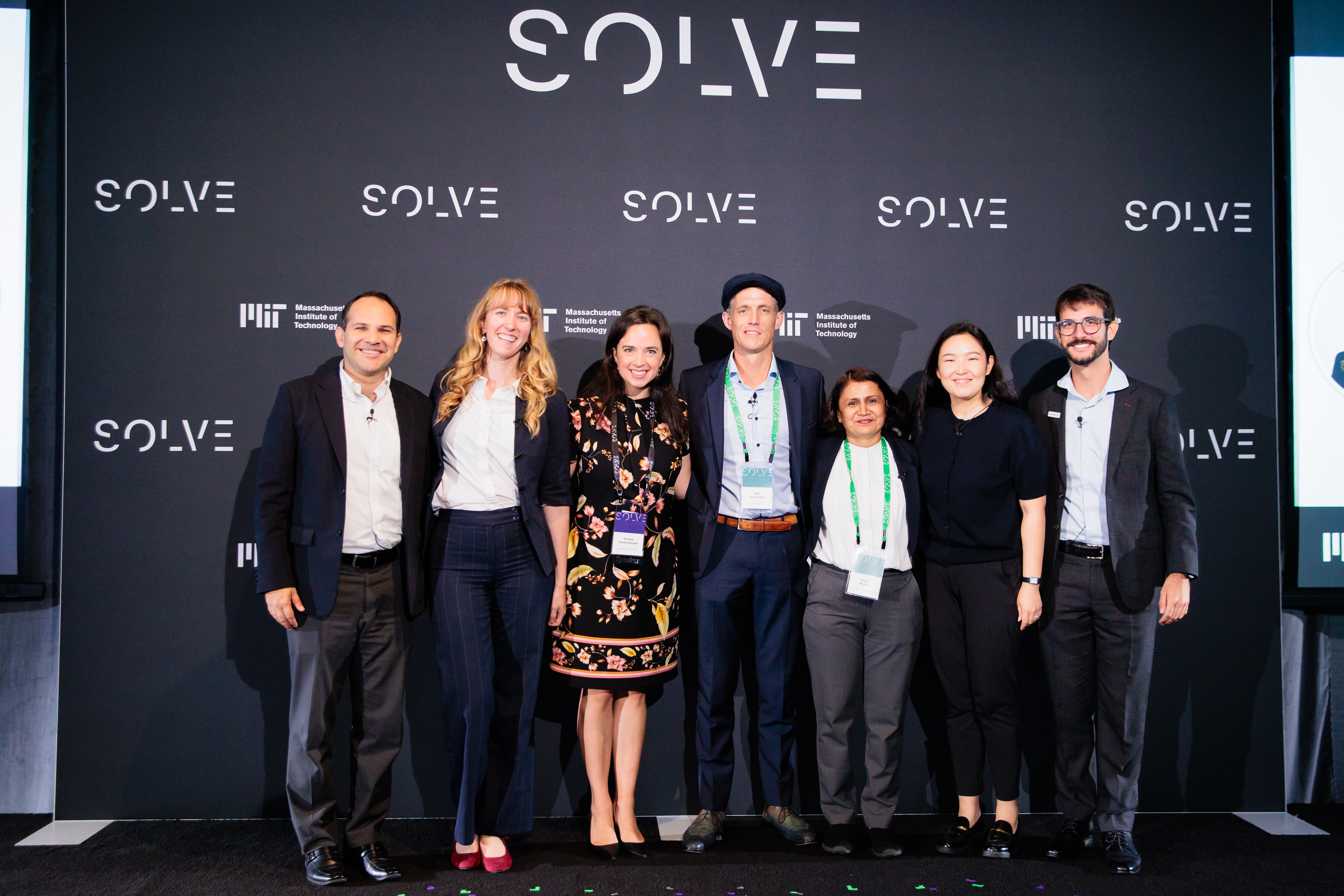 Group of participants standing together on stage at an event focused on health innovation.